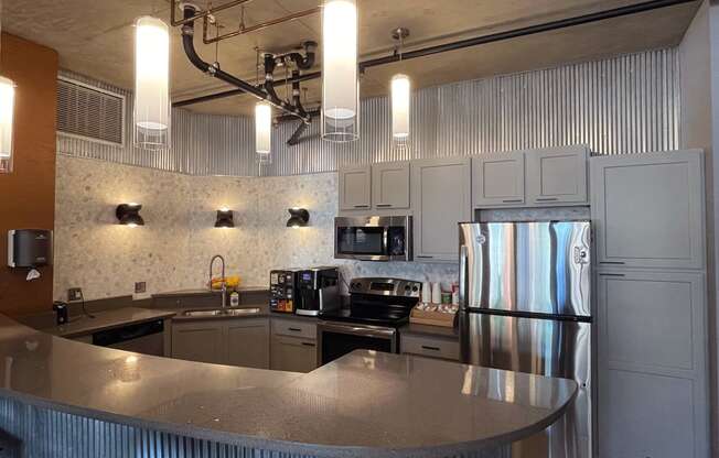 a kitchen with a large island and stainless steel appliances