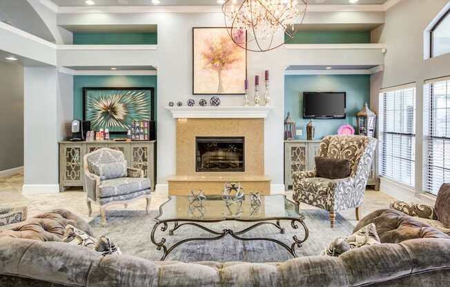 A living room with a fireplace and a chandelier.