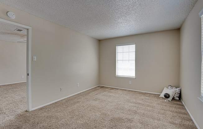 spacious bedroom with carpet & ceiling fan  at Arbors Of Cleburne, Texas