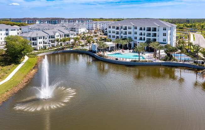a view of a body of water with a hotel and a fountain at Altis Grand Suncoast, Land O' Lakes