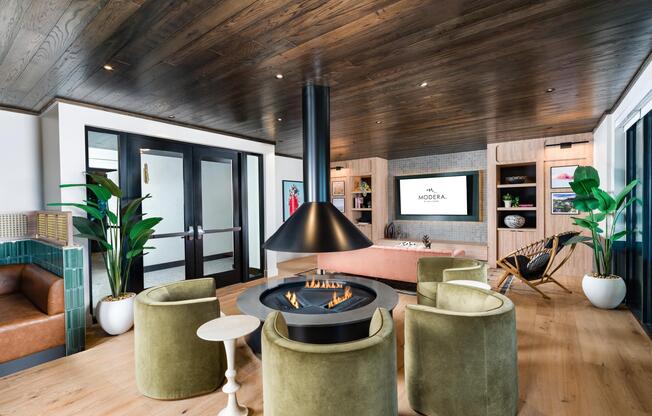 A thoughtfully designed lounge at Modera St. Paul features a modern fireplace, warm finishes, and inviting seating for gathering or unwinding in Dallas.