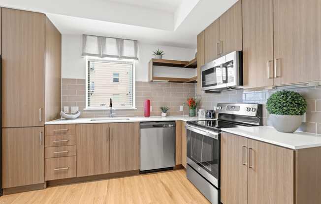 a kitchen with wooden cabinets and white countertops