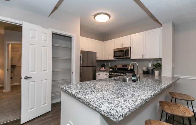 an open kitchen with a marble counter top at Willowest in Lindbergh, Georgia