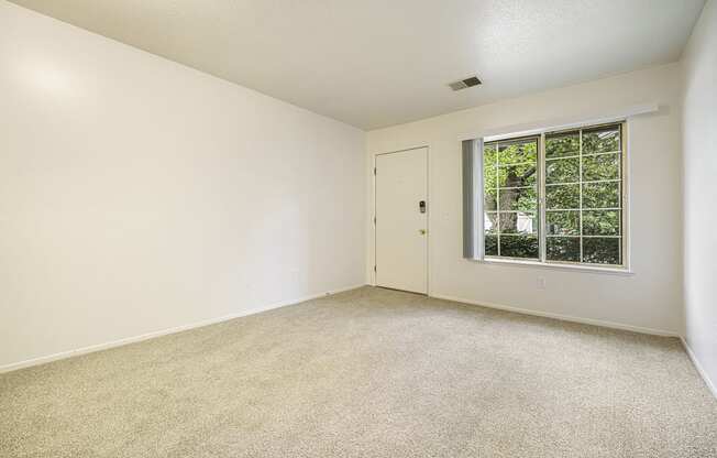 Main floor living with a large window at Newport Village Apartments, Portage, MI