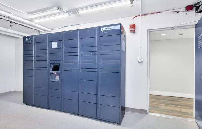 a set of blue lockers in a room with a door