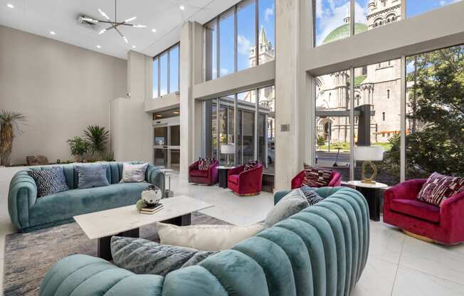 a living room filled with furniture and large windows