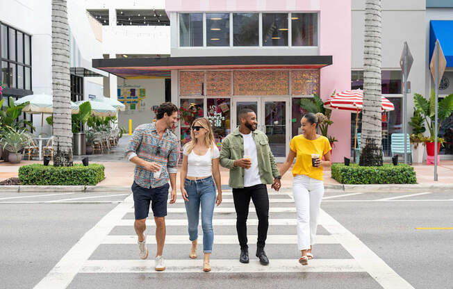 Four people are walking across a crosswalk. at Palma, Florida