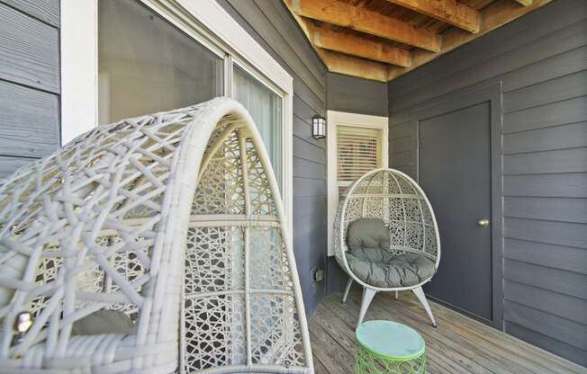 a porch with a white chair and a hammock at Elme Druid Hills, Atlanta, Georgia