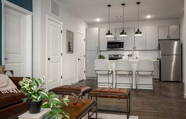 an open kitchen and living room with a table and chairs