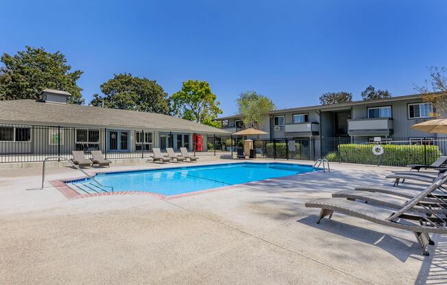 a group of lawn chairs sitting on top of a sandy beach