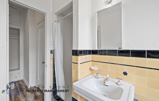 a bathroom with a sink and a mirror and a shower