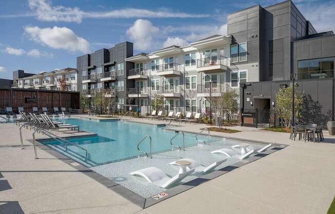 a swimming pool in front of an apartment building