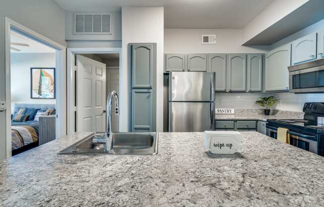 a kitchen with stainless steel appliances and granite counter tops