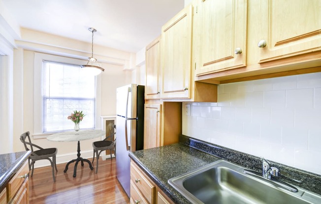 kitchen with view of dining area at wakefield hall apartments in washington dc
