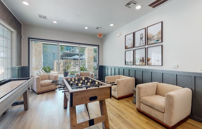 a game room with a foosball table and a ping pong table