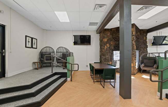 A room with a stone wall and a TV mounted on the wall.