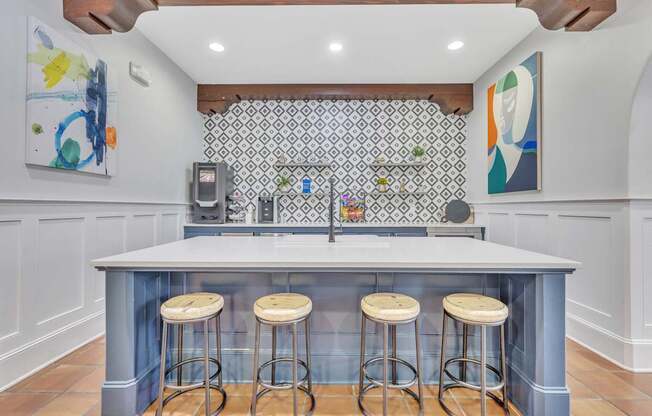 a kitchen with a blue counter top and four stools