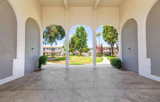 the archway of a building with a view of the grass at Sunnymead Apts Apartments, Moreno Valley, CA, 92553
