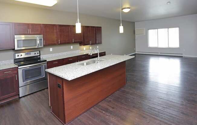 A kitchen with wooden cabinets and a stainless steel oven.
