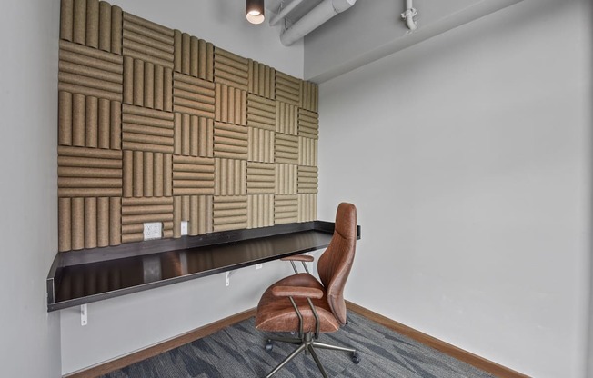 a chair sits in front of a long desk in an office
