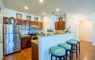 a kitchen with a breakfast bar and stainless steel appliances