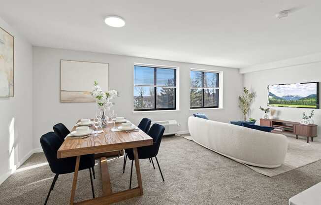 A dining room with a wooden table and chairs.