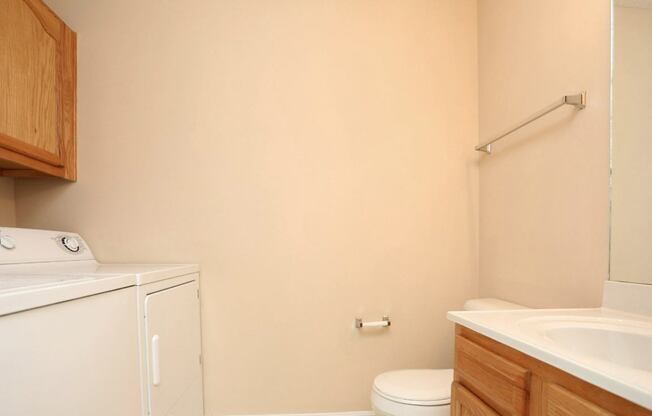 A small bathroom with a washer and dryer.