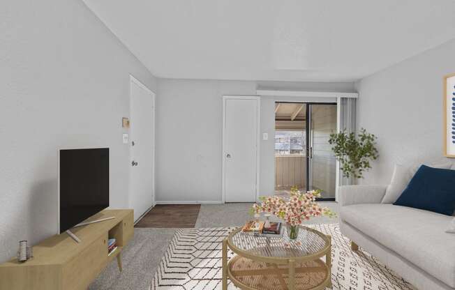 a living room with a white couch and a coffee table