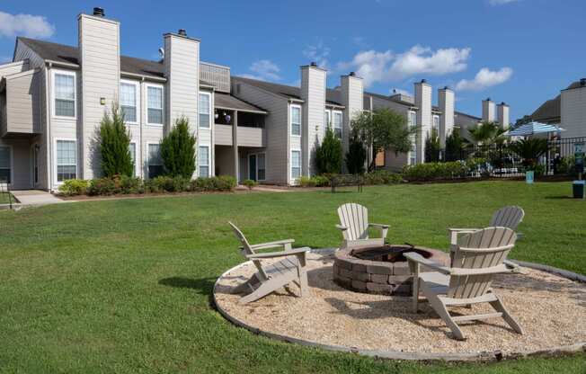 our apartments showcase a fire pit in the middle of our grassy area
