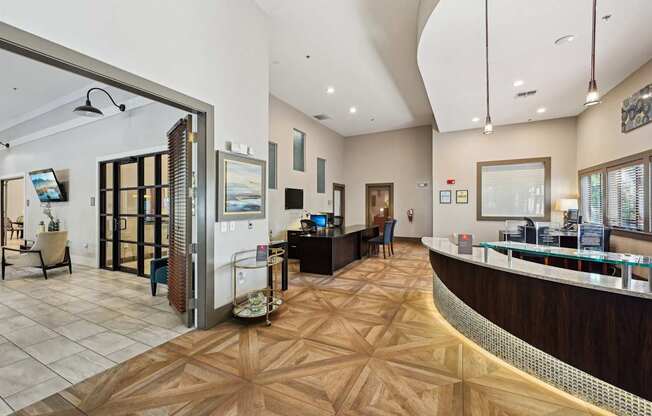 a lobby with a reception desk and a bar with a glass door