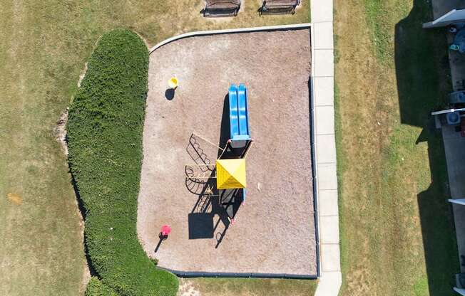 A yellow and blue striped umbrella is on a patio table.