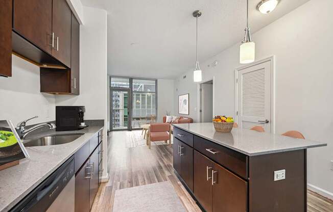 an open kitchen with a large island and a living room with a couch