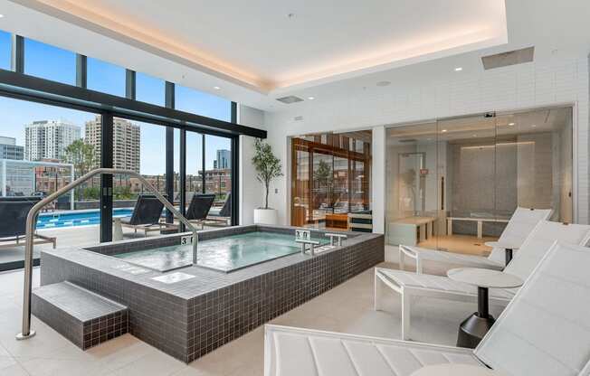 a spa area with a jacuzzi and a pool in a luxury apartment  at Cassidy on Canal, Chicago, 60606
