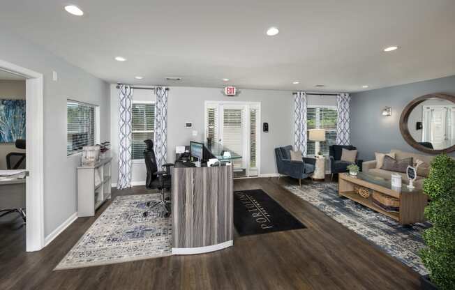 a living room with a desk and a couch and a rug