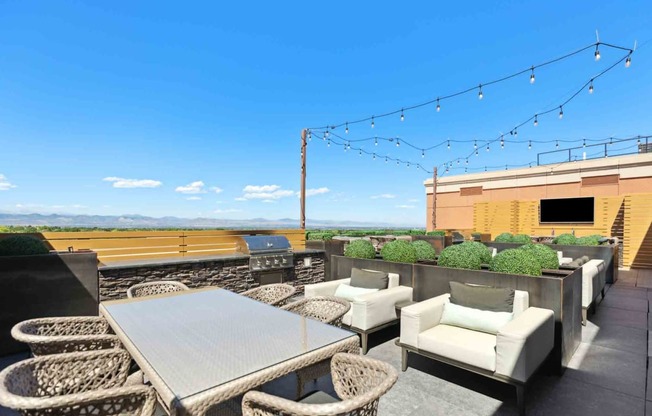 an outdoor patio with chairs and a table with a view of a field