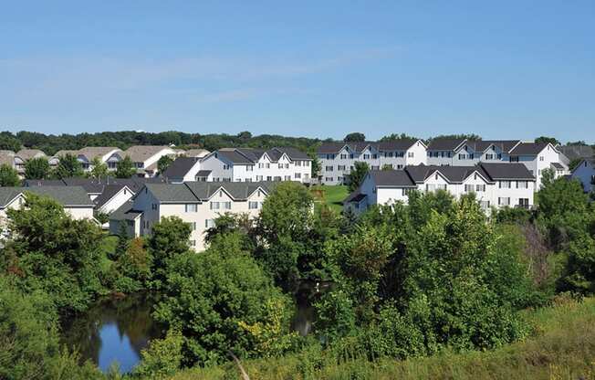 overlooking shot of multiple townhomes and trees