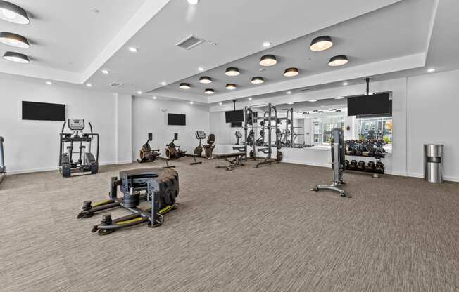 a gym with weights and other exercise equipment in a large room