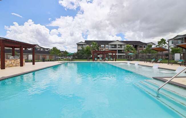 A large swimming pool in front of a building.