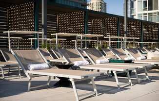 a row of chaise lounges on the roof of a building