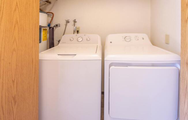 A white washing machine and dryer in a small laundry room.