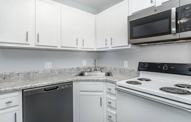 a stove top oven sitting inside of a kitchen