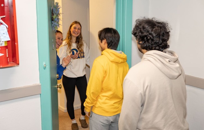 a group of people standing in front of a mirror