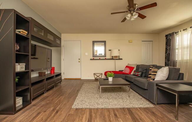 a living room filled with furniture and a flat screen tv