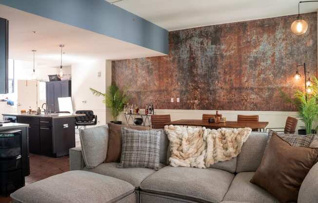 a living room with a couch and a wall with a mural on it