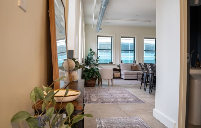 a living room with a view of a dining room and a kitchen