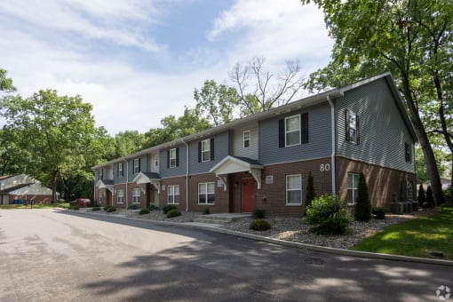 a street view of an apartment building with a driveway