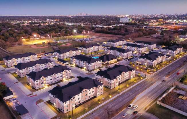 an aerial view of a neighborhood at night at 55 Fifty at Northwest Crossing, Texas, 77092