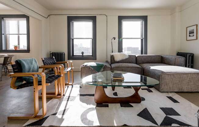 a living room with a couch and a glass coffee table