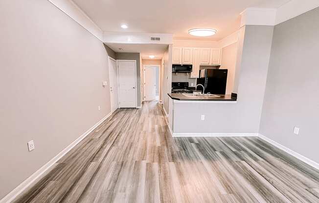 an empty living room and kitchen in a new home