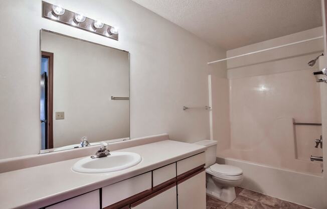 Grand Forks Primrose Apartments. A bathroom with a sink and a toilet